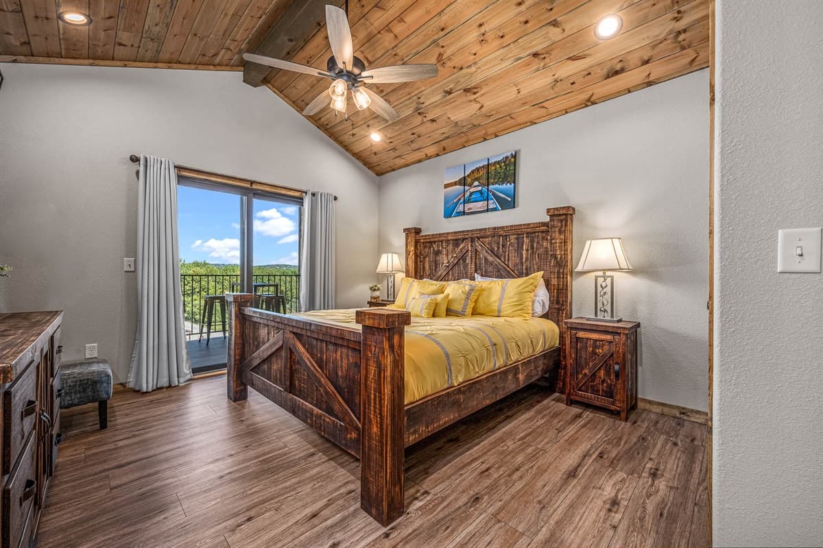 Main level King bedroom #1 with ensuite bathroom and sliding door out to upper deck