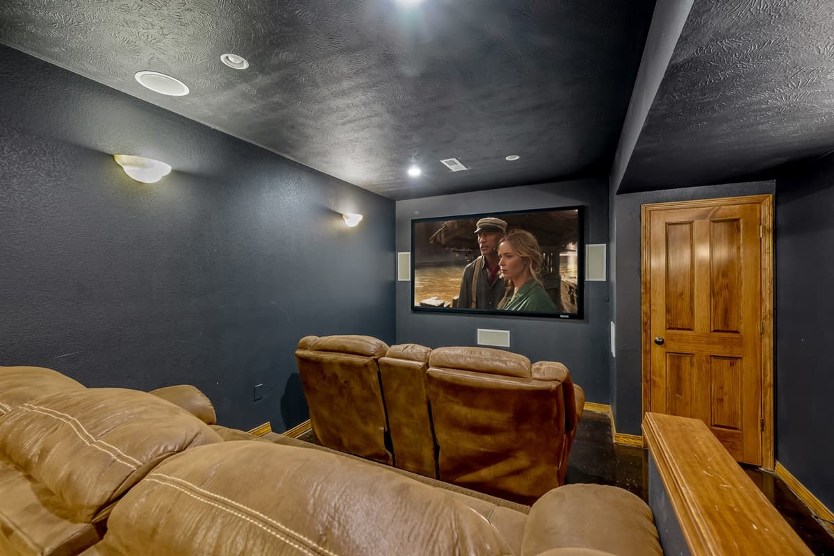 Theater room with 3 levels of seating, fantastic surround sound, & projection tv