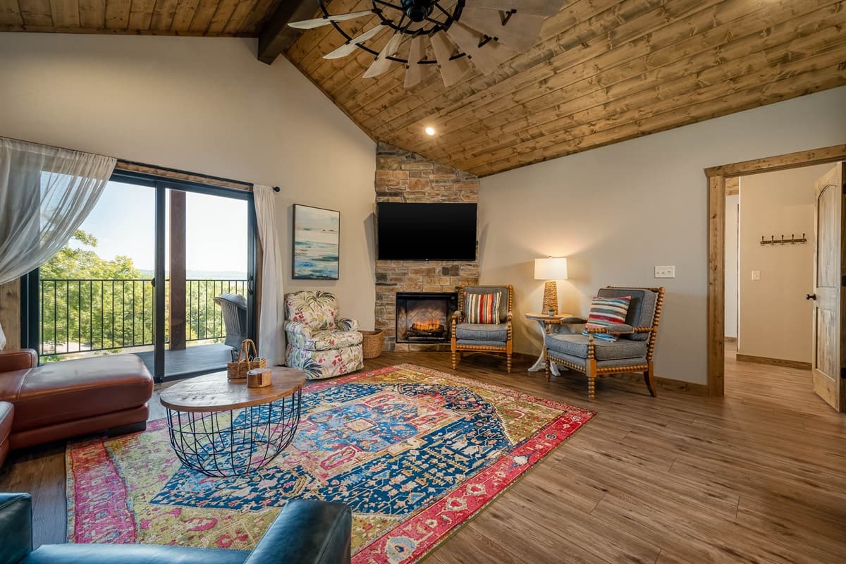 Lovely living area with fireplace and deck overlooking the community pool and hot tub