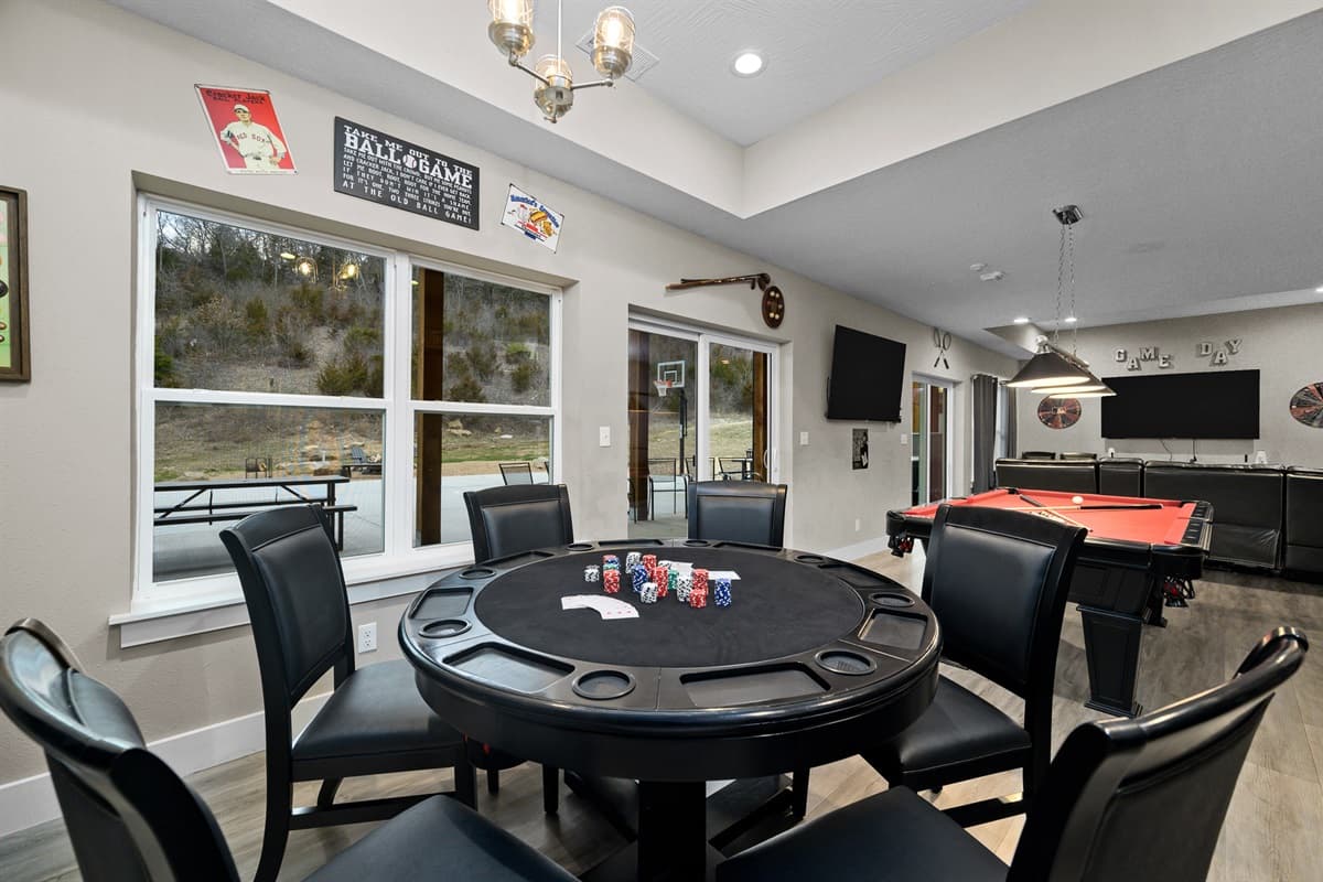 Game room with poker table and pool table.